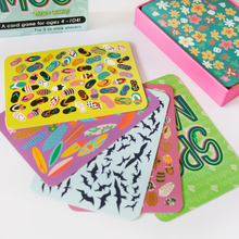 Load image into Gallery viewer, 5 different Spot da Mo‘o cards (bright green with slippers, purple with surfboards, light blue with birds, pink with seashells, and dark green with flowers)