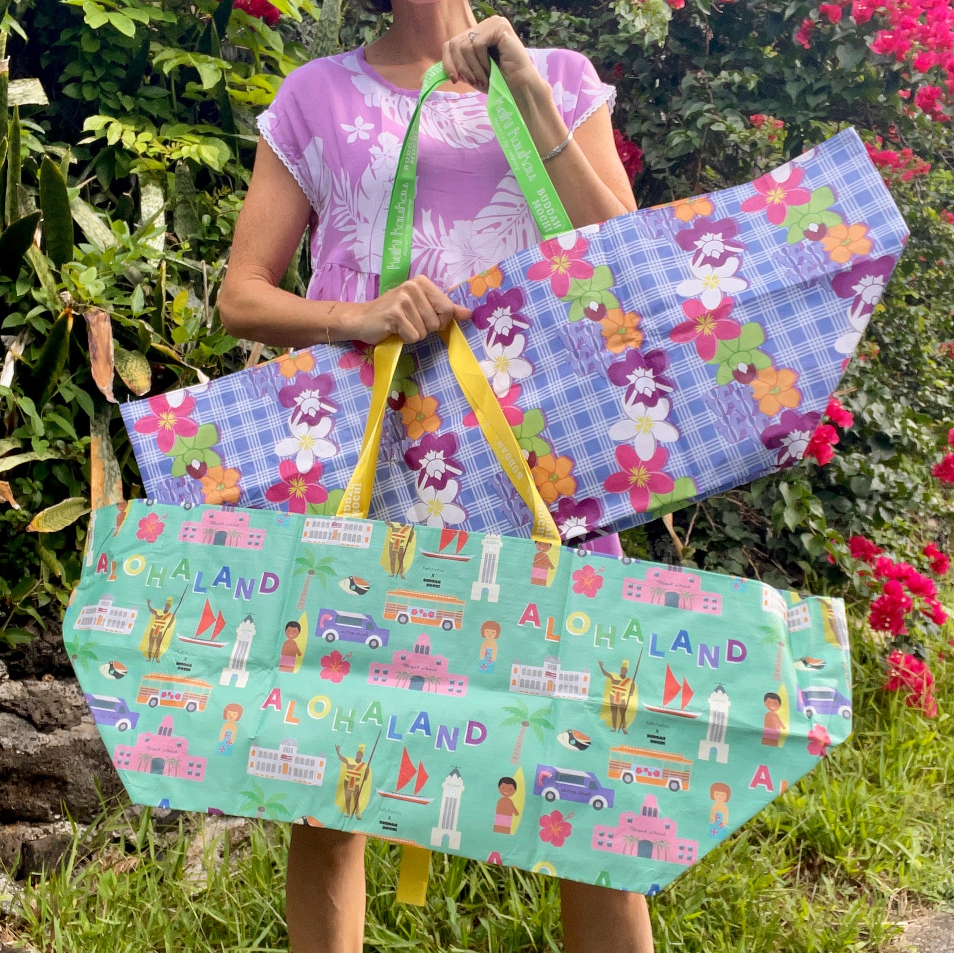 Woman holding two large colorful tote bags