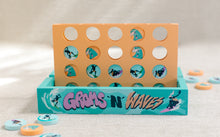 Load image into Gallery viewer, Orange and teal 4-in-a-row game reading "Groms 'n' Waves"
