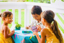 Load image into Gallery viewer, two girls and a boy playing with the bingo game at a table