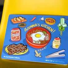 Load image into Gallery viewer, Blue wooden puzzle with 8 block pieces (mandoo, gamja jorim, melon ice cream bar, kimchi jar, bibimbap, banana milk drink, kalbi, and chop sticks) reading "Ajumma's Kitchen!"