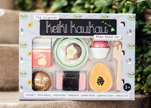 Load image into Gallery viewer, Purple box reading "the original keiki kaukau Play food set" with plastic window showing wooden toys (a guava juice carton, a loco moco, a shave ice, a fork and spoon, a malasada, a spam musubi, and a papaya)