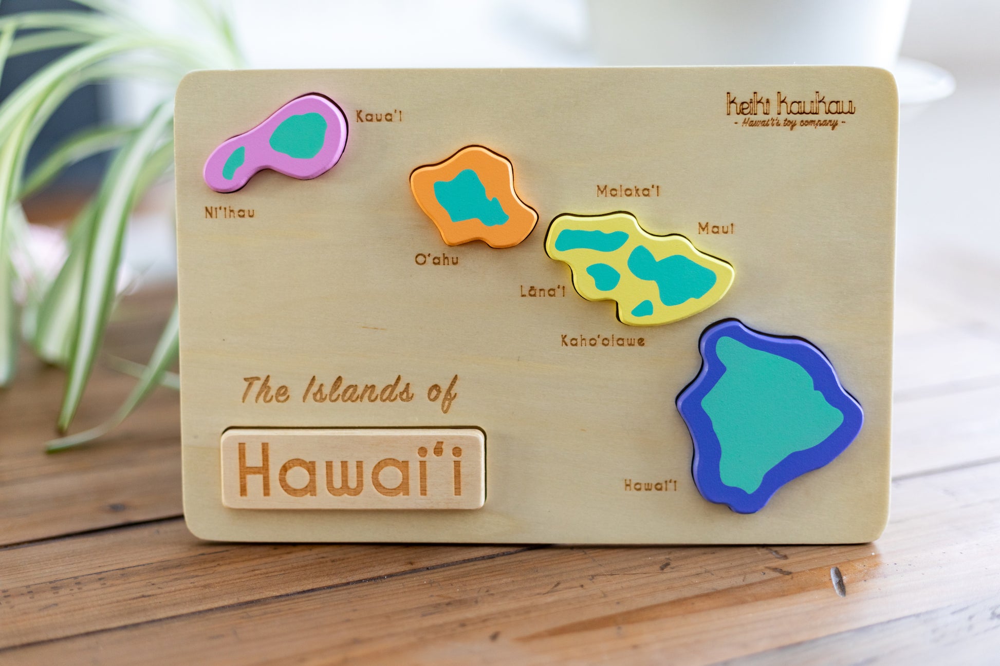 Completed wooden puzzle of the Hawaiian island chain with all 5 pieces