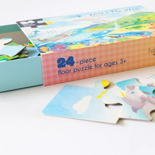 Load image into Gallery viewer, Side view of open  puzzle box reading &quot;24 - piece floor puzzle for ages 3+,&quot; showing three puzzle pieces close-up