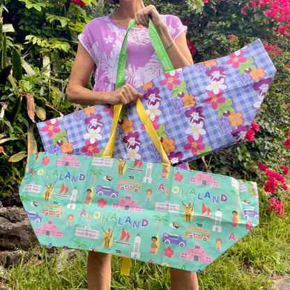 Woman holding two large colorful tote bags
