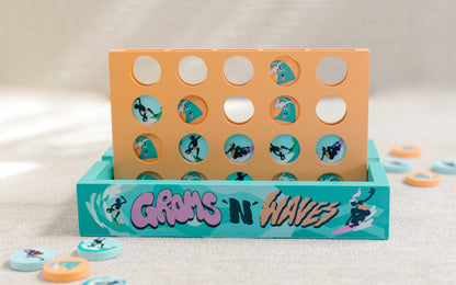 Orange and teal 4-in-a-row game reading "Groms 'n' Waves"