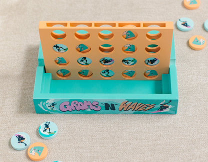 4-in-a-row game with teal surfer and orange wave playing pieces 