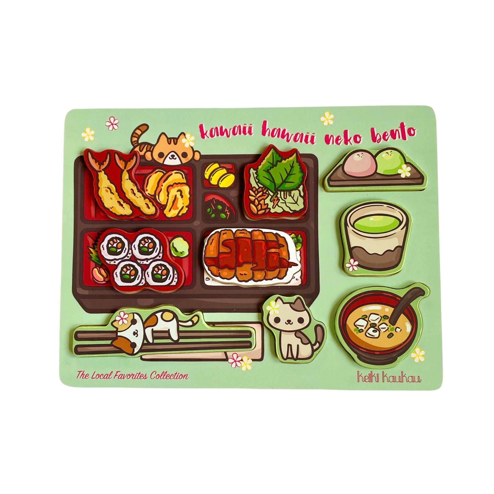 Green wooden block puzzle reading "kawaii hawaii neko bento" with nine puzzle pieces (tempura, sushi, white cat with chopsticks, brown cat with flower, katsu, salad, pink and green mochi, teacup, and miso soup bowl)