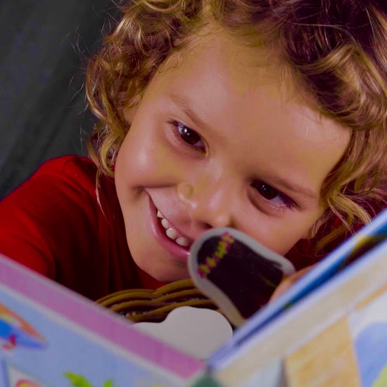 little kid holding open Pop-Up Dollhouse book