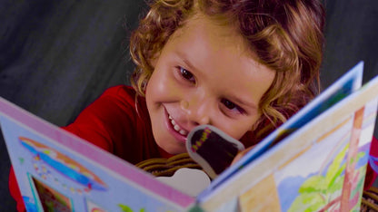 little kid holding open Pop-Up Dollhouse book