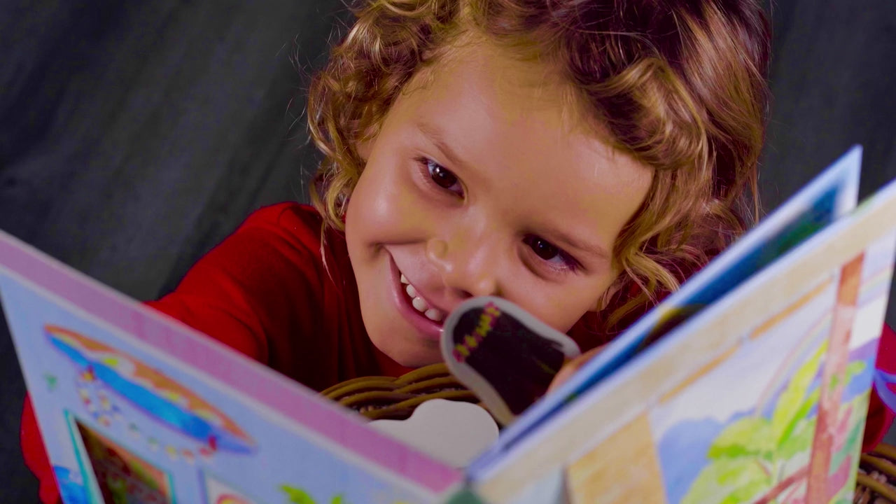 little kid holding open Pop-Up Dollhouse book