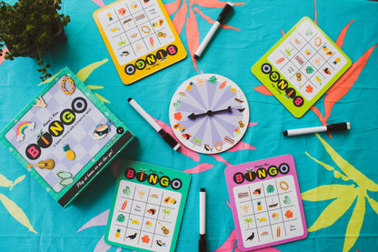Four sets of bingo cards and erasable markers around a spinning wheel with bingo card graphics 