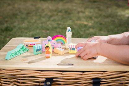 a child's hands playing with the ALOHALAND blocks