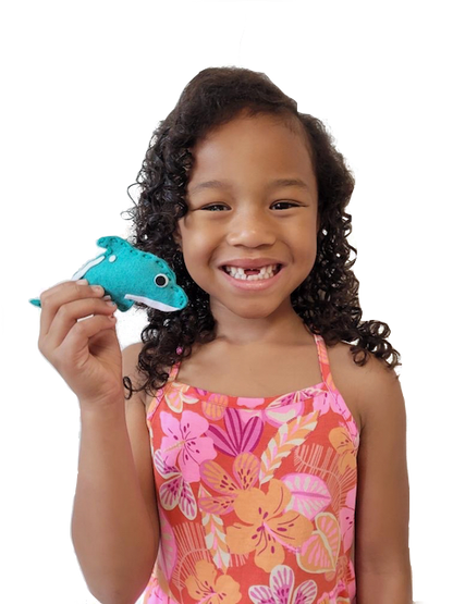 Little girl holding sewn teal dolphin