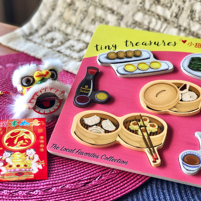 Close-up of Dim sum puzzle pieces (Shoyu bottle, Egg tarts and Jin dui,  Char siu bao, and Dim sum basket)
