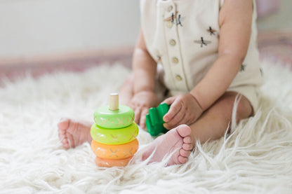 baby with the yellow wooden pineapple stacking toy