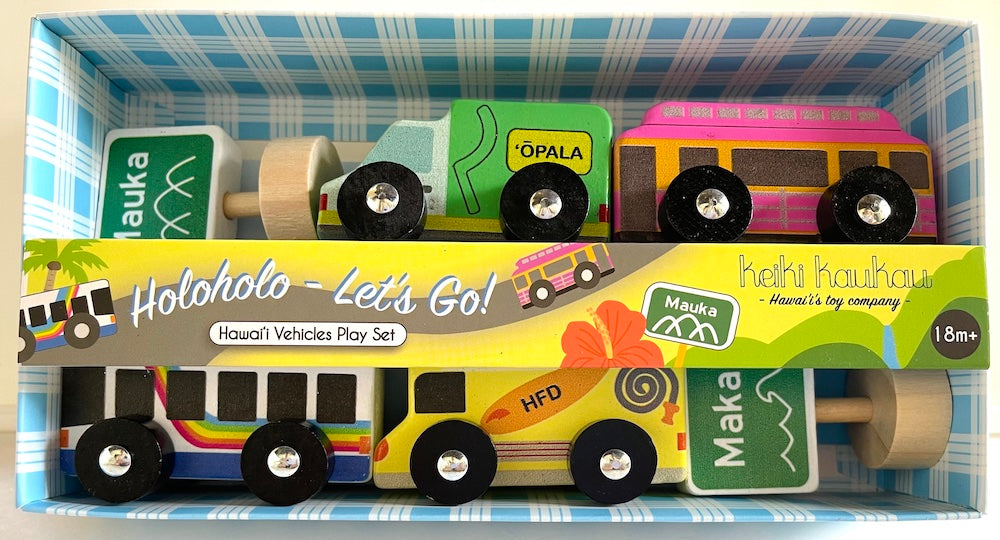 Four wooden cars (garbage truck, trolly, bus, and fire truck) with two street signs in a blue and white palaka box with label reading "Holoholo- Let's Go! Hawai'i Vehicles Play Set"